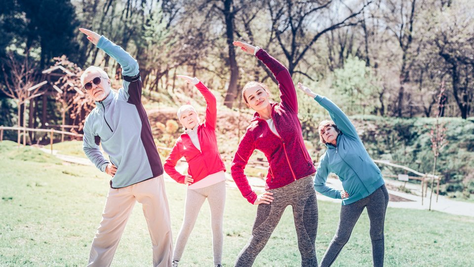 Men and women wearing sport clothes doing sport outside