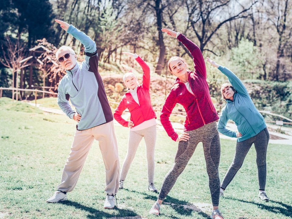 Men and women wearing sport clothes doing sport outside