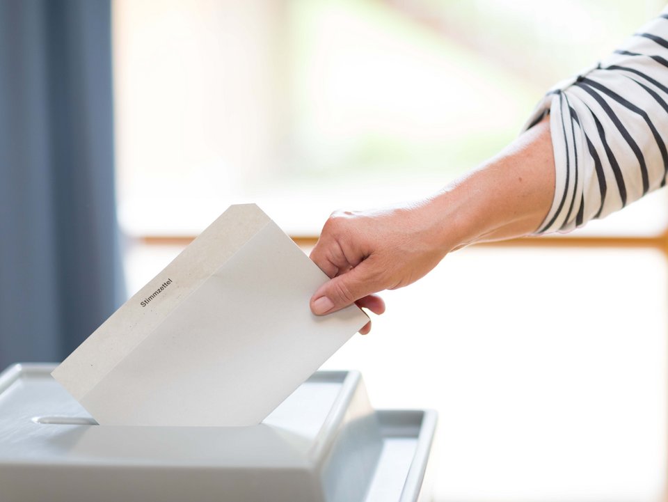 Stimmzettel wird in Wahlurne geworfen image-44343